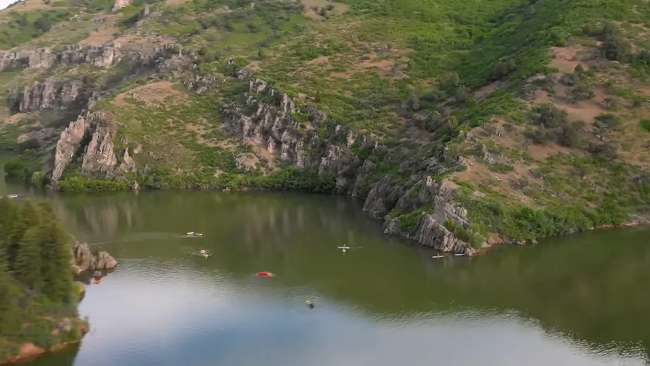Paddlers and calm water on a reservoir representing river and trail recreation