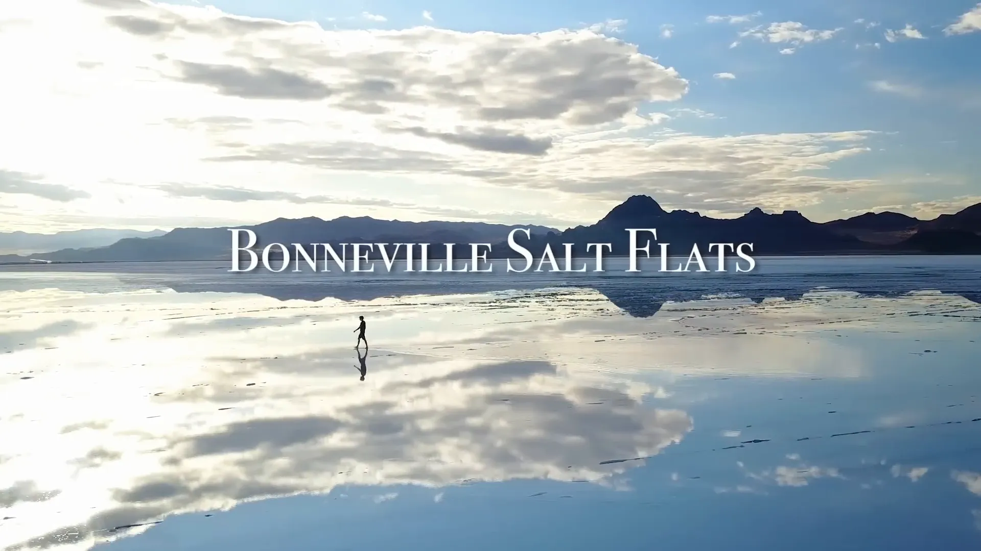 Expansive view of Bonneville Salt Flats with white salt crust and surrounding mountains