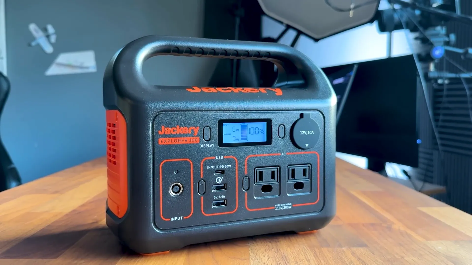 Jackery E300 portable power station with cables and carrying pouch