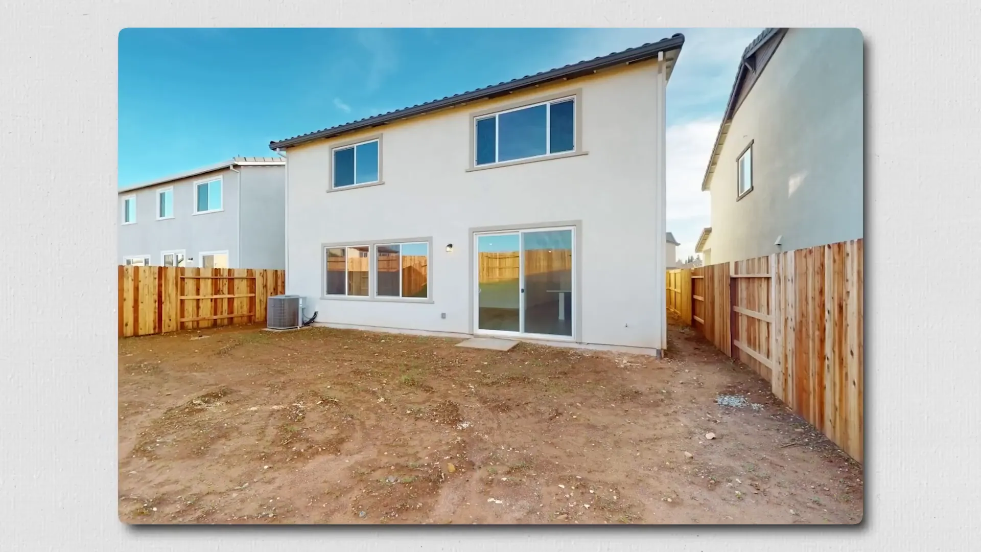 Unlandscaped dirt backyard at new construction home