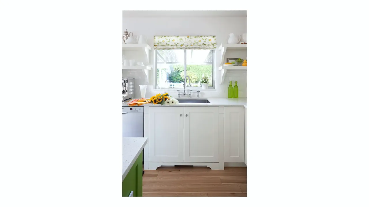 Kitchen with white-on-white cabinetry and a warm-toned painted island as contrast