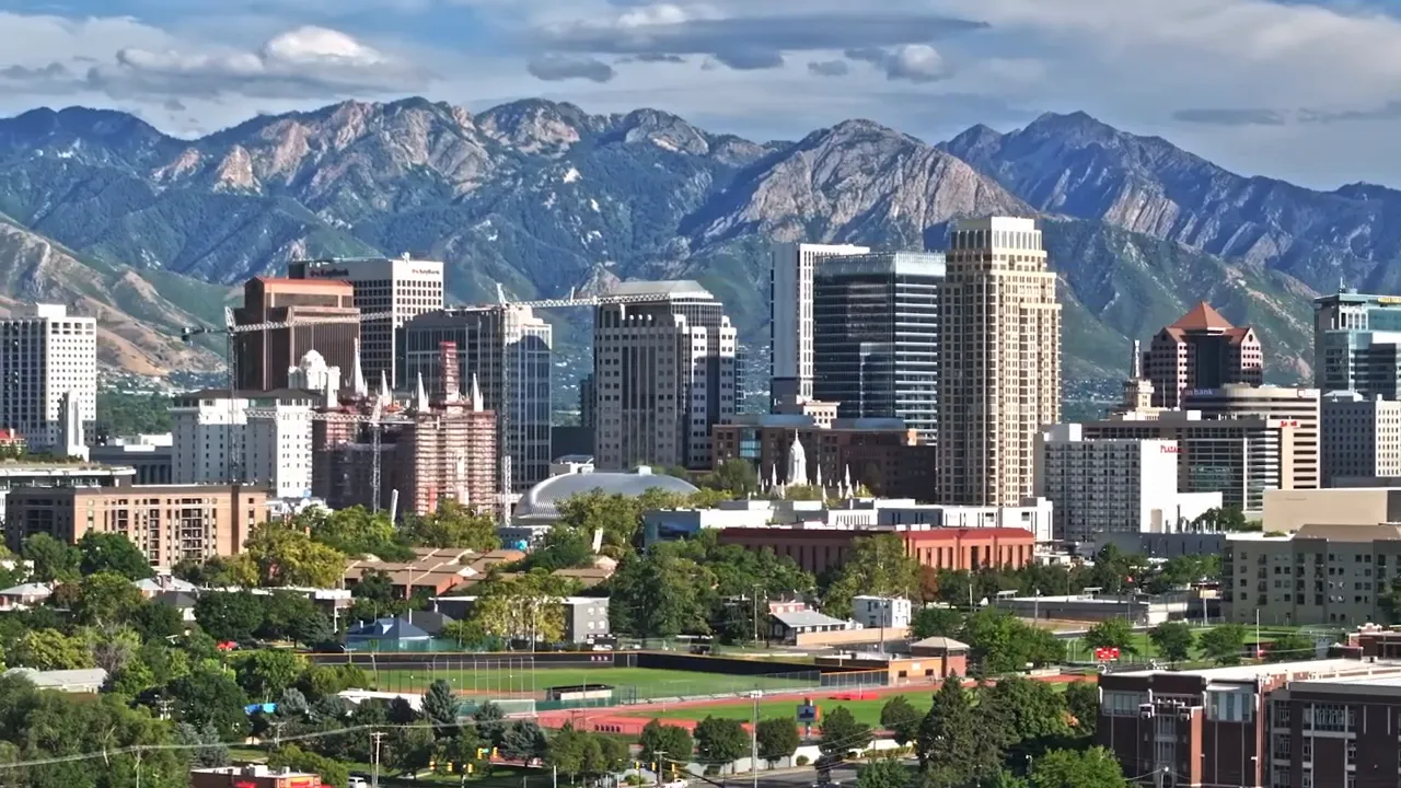 Salt Lake City downtown skyline with high‑rise buildings and the Wasatch Mountains in the background