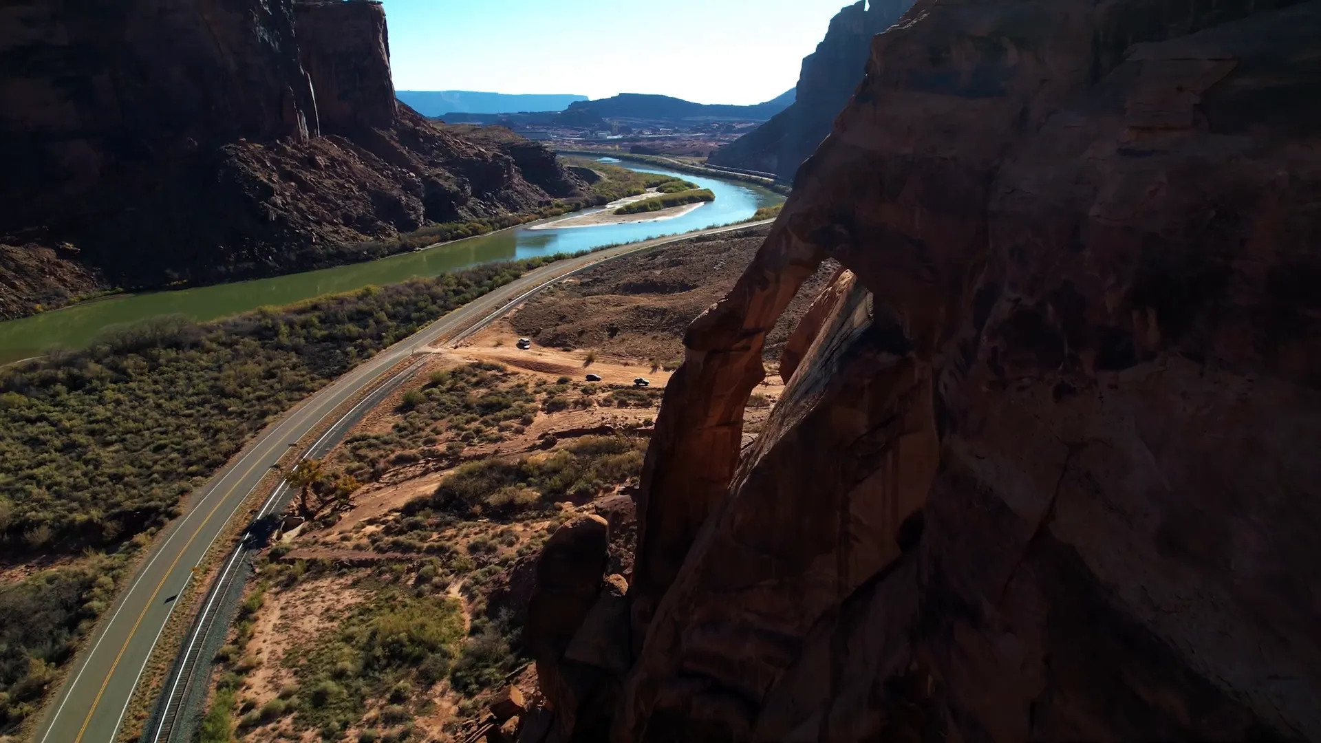 Jug Handle Arch sandstone arch alongside road with river and canyon views