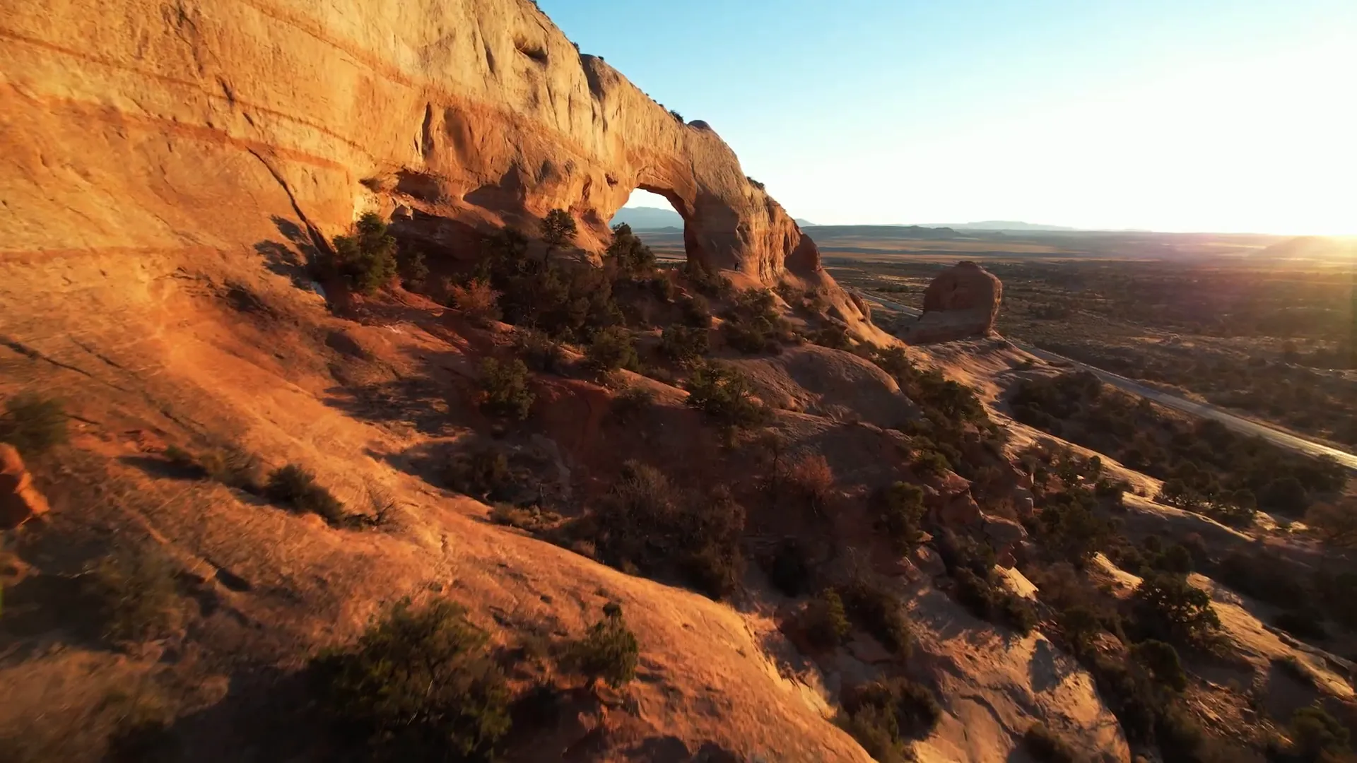 Wilson Arch large sandstone arch with clear sky backdrop near Moab