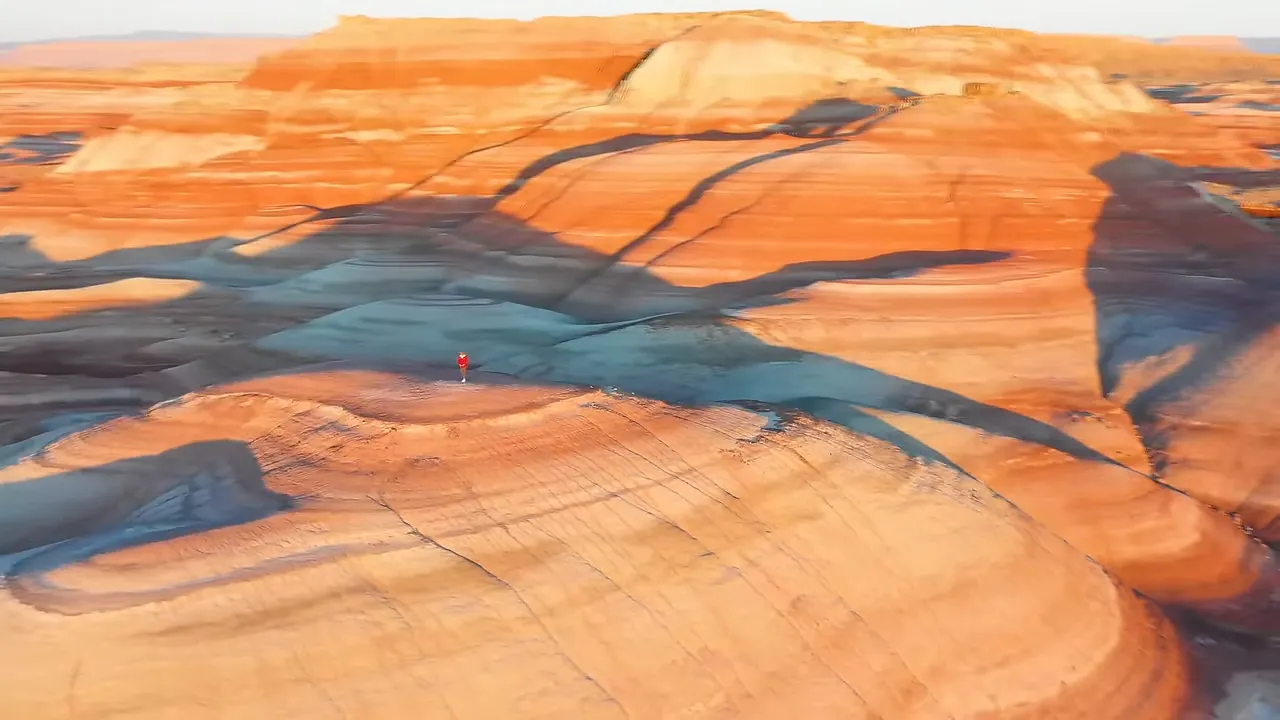 A crimson and purple layered rock landscape under sunrise light, suggesting a Martian-like terrain