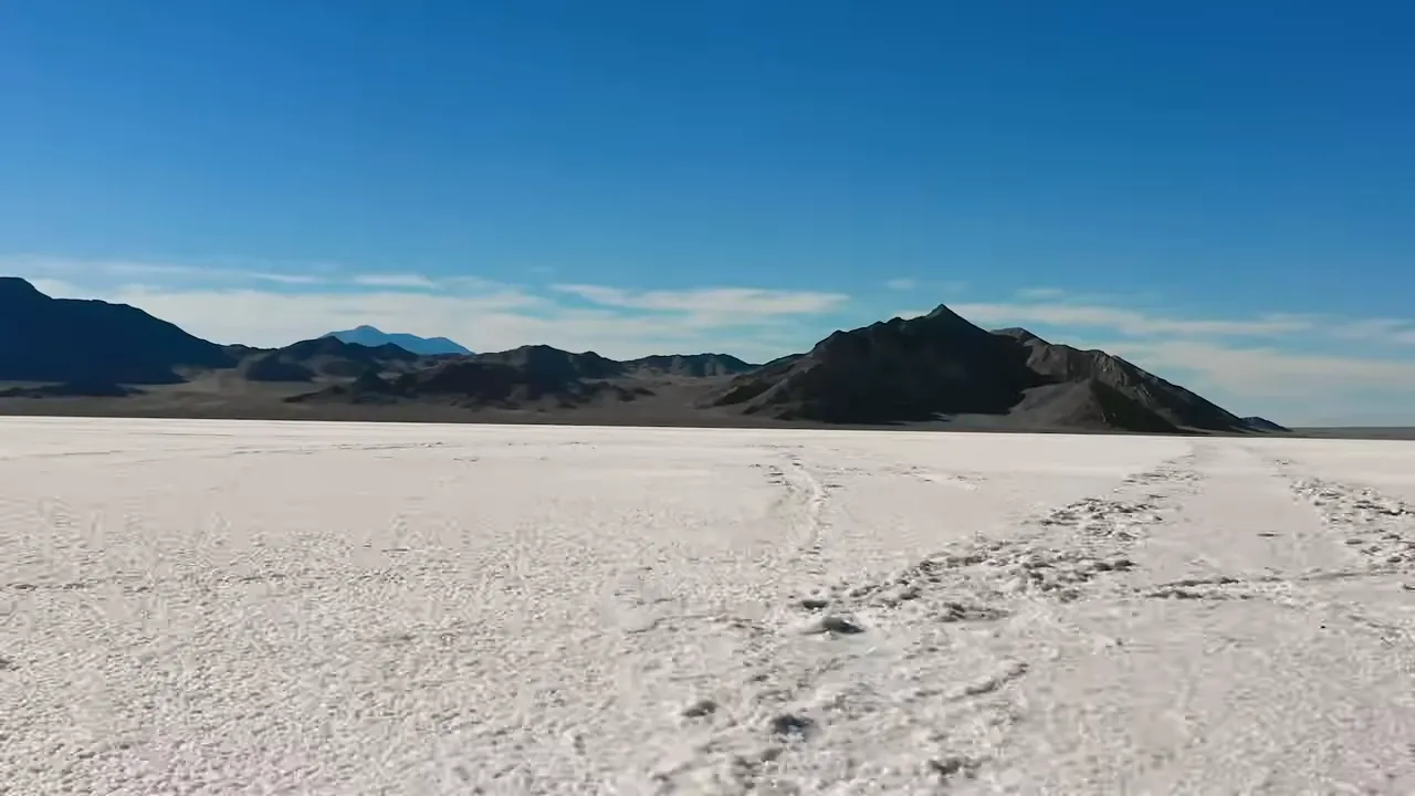 Wide white expanse of Bonneville Salt Flats with mountains in the distance