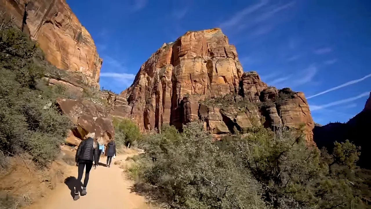 Steep red cliffs and high-elevation trail similar to Big Cottonwood Canyon