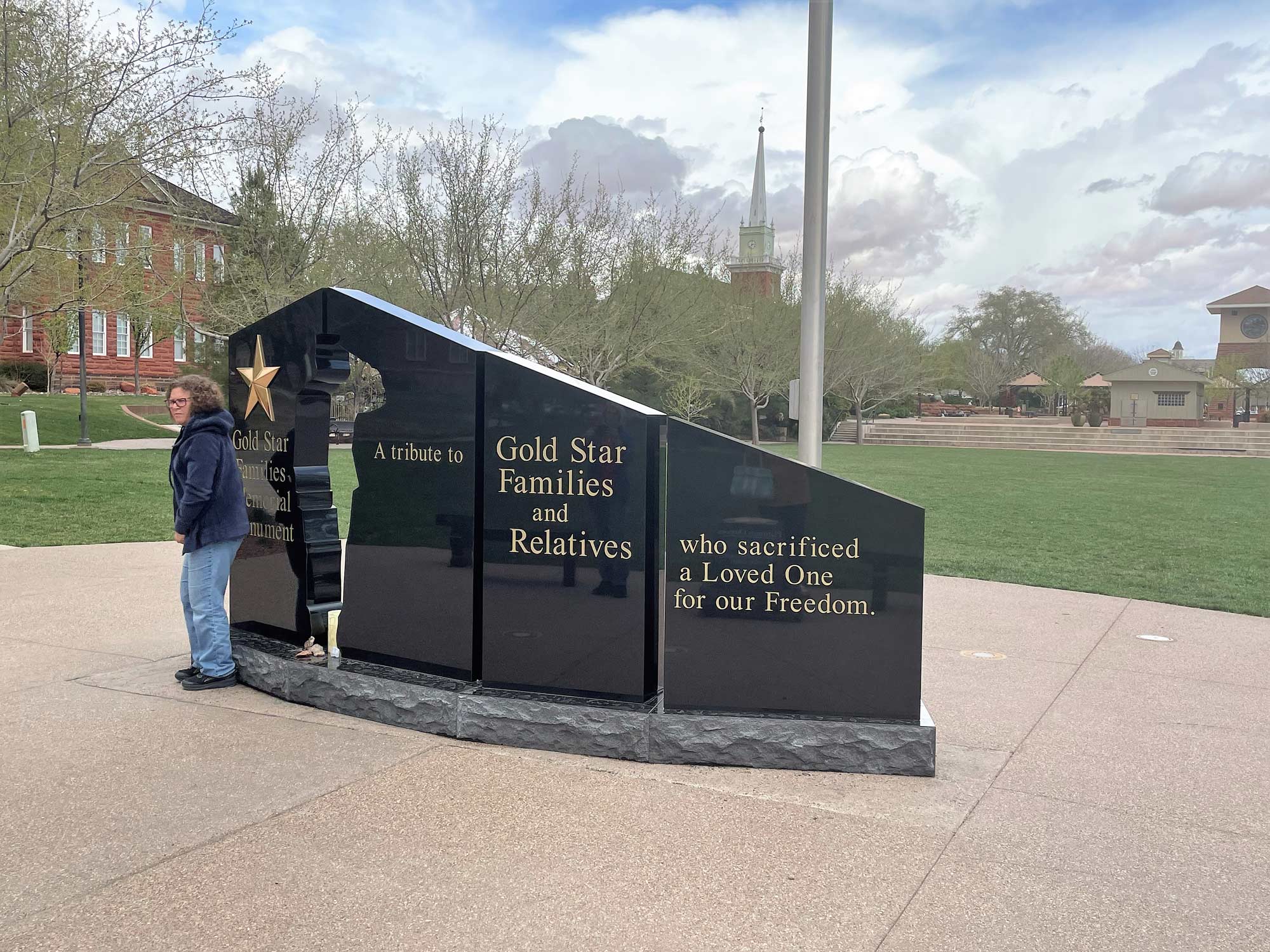 Person standing in front of Gold Star Family Memorial Monument St George Utah