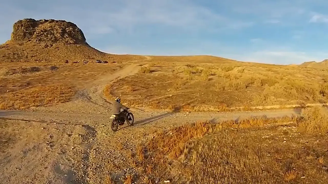 Dirt trail near Five Mile Pass with riders and desert landscape