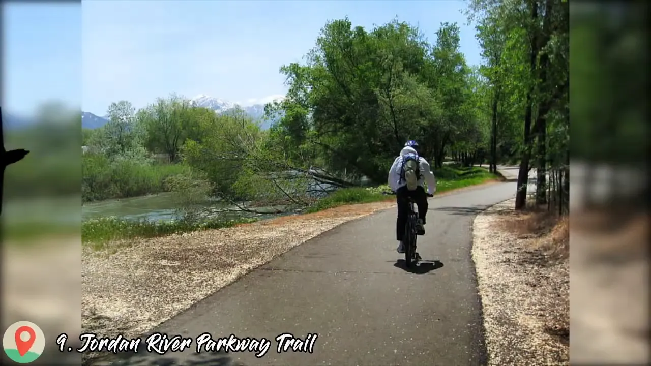 Scenic paved trail running beside a river with trees