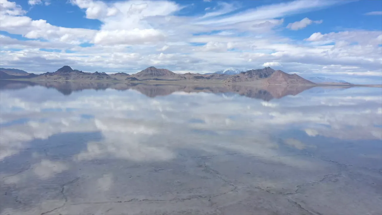 A wide salt flat landscape with reflective surface after rain