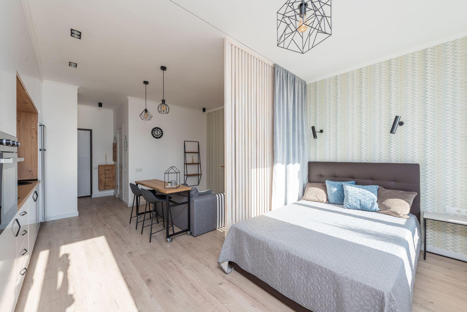 Studio apartment with a sleeping area, small dining table and kitchen in one room